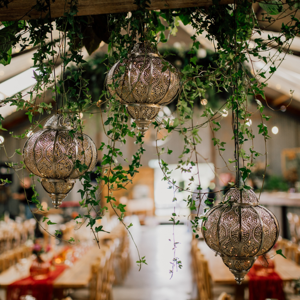 Suspended living plant installation with cascading foliage creating an eye-catching botanical wedding ceiling feature.