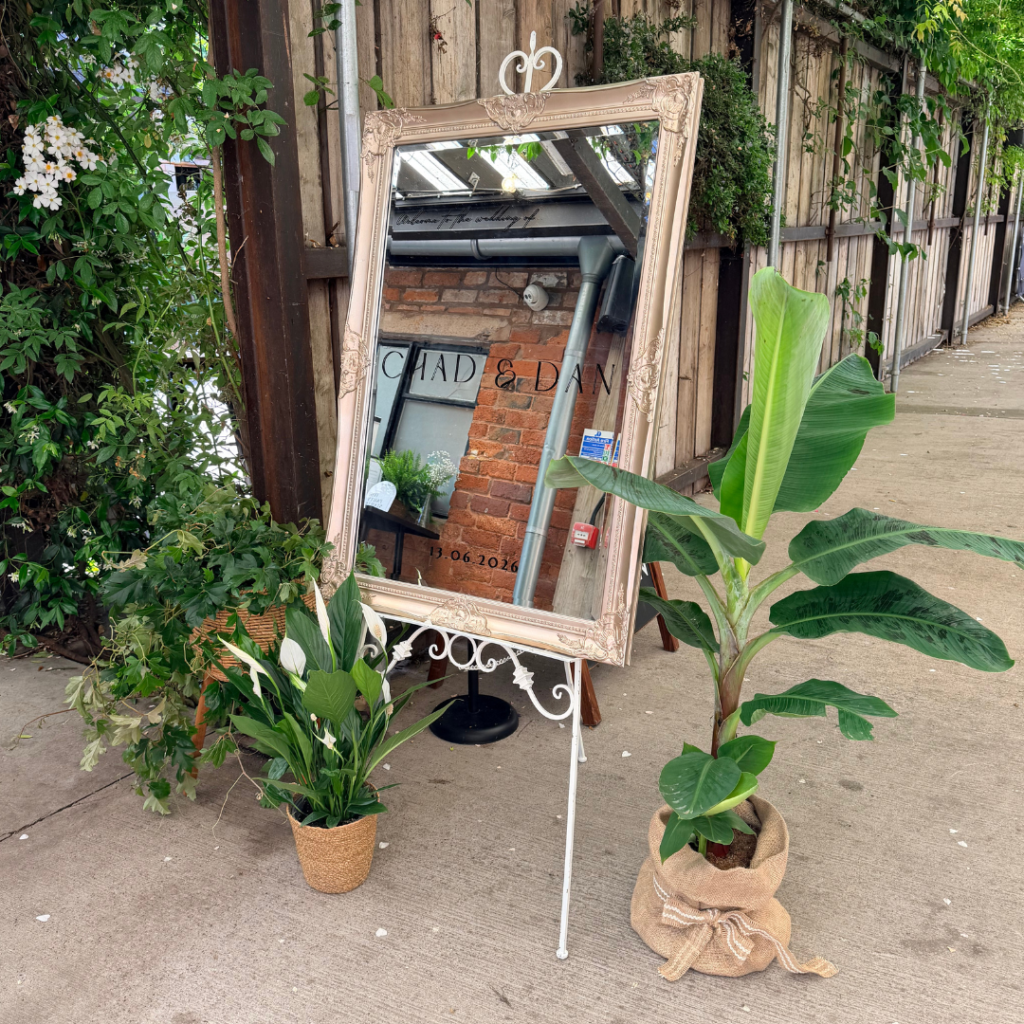 Wedding mirror sign styled with freestanding living plants